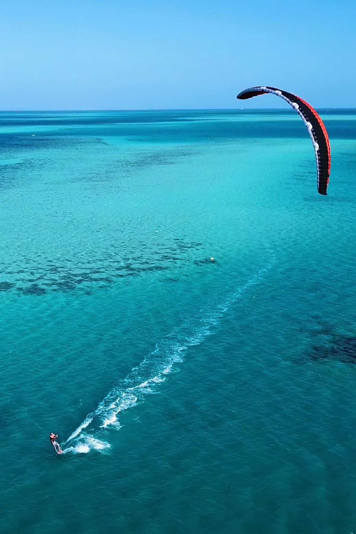 A man kite surfs across the deep blue waters in El Gouna, near Hurghada in Egypt.